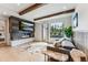 Living room boasts a sleek fireplace, wooden beams, large window with mountain views at 427 Whispering Pines Cir, Breckenridge, CO 80424