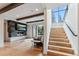 Spacious living room with fireplace, hardwood floors, wooden ceiling beams and staircase at 427 Whispering Pines Cir, Breckenridge, CO 80424