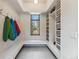 Organized mudroom with built-in storage, hooks, bench seating, and scenic window view at 427 Whispering Pines Cir, Breckenridge, CO 80424