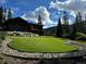 Beautifully landscaped backyard with a green lawn and decorative rock borders at 427 Whispering Pines Cir, Breckenridge, CO 80424