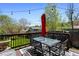 A beautifully decorated deck with a dark table and chairs, an umbrella, and decorative string lights at 214 Poppy St, Golden, CO 80401