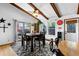 Bright and open dining area with exposed beams, a ceiling fan, and large windows offering ample light at 214 Poppy St, Golden, CO 80401