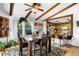 Inviting dining room featuring exposed beams, wood floors, and an open layout with a kitchen view at 214 Poppy St, Golden, CO 80401