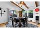Bright dining room with exposed beams, a ceiling fan, and sliding glass doors to an outdoor patio at 214 Poppy St, Golden, CO 80401