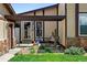 Inviting front porch features a cozy bench, desert plants, and stylish decor, enhancing its curb appeal at 214 Poppy St, Golden, CO 80401