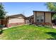 Charming single-story house featuring a well-manicured lawn and partial stone facade, creating inviting curb appeal at 214 Poppy St, Golden, CO 80401