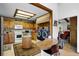 Charming kitchen featuring wood cabinets, an island, adjacent laundry, and a breakfast bar with seating at 214 Poppy St, Golden, CO 80401