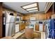 Well-equipped kitchen featuring wood cabinets, modern appliances, an island, and adjacent laundry area at 214 Poppy St, Golden, CO 80401