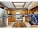 Cozy kitchen showcasing wooden cabinets, modern appliances, a unique center island, and laundry area at 214 Poppy St, Golden, CO 80401