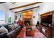 Spacious living room with exposed beam ceiling, fireplace, and large window offering abundant natural light at 214 Poppy St, Golden, CO 80401