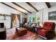 Open-concept living room boasts a bright atmosphere, exposed beam ceiling, and stylish furnishings at 214 Poppy St, Golden, CO 80401