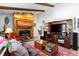 Comfortable living room with exposed beam ceiling, a cozy fireplace, and an open layout perfect for entertaining at 214 Poppy St, Golden, CO 80401