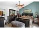 Spacious main bedroom with a large bed, dark furniture, ceiling fan, and teal accent wall at 214 Poppy St, Golden, CO 80401