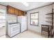 Functional kitchen featuring white appliances, upper cabinetry, and neutral flooring at 520 Tennyson St, Denver, CO 80204