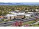 Aerial view of a commercial community with shopping, dining, trees and mountain views at 10151 W 38Th Ave, Wheat Ridge, CO 80033