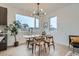 Bright dining room with modern lighting, large windows and views of neighborhood at 10151 W 38Th Ave, Wheat Ridge, CO 80033