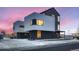 Contemporary home features clean lines, mixed materials, and vibrant sunset backdrop at 10151 W 38Th Ave, Wheat Ridge, CO 80033