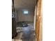 Unfinished basement with concrete walls, a small window, and a gray water heater at 405 Dogwood Ave, Brighton, CO 80601