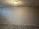 Unfinished basement with concrete walls and floor, illuminated by a light fixture at 405 Dogwood Ave, Brighton, CO 80601