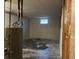 Unfinished basement with concrete walls, a small window, and a gray water heater at 405 Dogwood Ave, Brighton, CO 80601