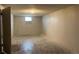 Unfinished basement with concrete walls, floor, and a window at 405 Dogwood Ave, Brighton, CO 80601