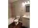Bathroom featuring a tub, toilet, and vanity, complemented by neutral-toned walls and wood-look flooring at 405 Dogwood Ave, Brighton, CO 80601