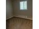 Cozy bedroom features a window that lets in natural light and neutral-toned walls and carpet at 405 Dogwood Ave, Brighton, CO 80601