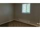 Bedroom featuring a window that lets in natural light and neutral-toned walls and carpet at 405 Dogwood Ave, Brighton, CO 80601