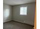 Bedroom featuring a window that lets in natural light and neutral-toned walls and carpet at 405 Dogwood Ave, Brighton, CO 80601