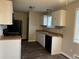 Functional kitchen with white cabinetry, updated appliances, and ample counter space, making meal preparation a breeze at 405 Dogwood Ave, Brighton, CO 80601