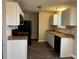 Well-lit kitchen featuring white cabinets, sleek appliances, and a modern sink, creating a clean and efficient cooking space at 405 Dogwood Ave, Brighton, CO 80601