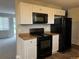 Updated kitchen with open layout, modern appliances, and direct access to the living area, perfect for entertaining and cooking at 405 Dogwood Ave, Brighton, CO 80601