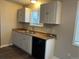 Practical kitchen space with a double sink, abundant counter space, and storage cabinets, perfect for culinary enthusiasts at 405 Dogwood Ave, Brighton, CO 80601