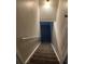 Carpeted staircase leading downwards, complemented by a handrail and neutral-toned walls at 405 Dogwood Ave, Brighton, CO 80601