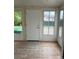 Cozy sun room with wood flooring and multiple windows offering natural light at 405 Dogwood Ave, Brighton, CO 80601