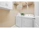 A clean laundry room with a washer and dryer, storage and shelving at 2897 Hillcroft Ln, Castle Rock, CO 80104