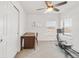 Bright room with carpet featuring a desk, chair, exercise machine, and two windows at 11905 Quitman St, Westminster, CO 80031