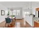 Open-concept dining room with hardwood floors, modern lighting, and easy access to the kitchen at 11905 Quitman St, Westminster, CO 80031