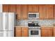 Close up of the kitchen, features include granite countertops and stainless steel appliances at 11905 Quitman St, Westminster, CO 80031