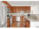 Well-lit kitchen features stainless steel appliances, granite countertops, and a beautiful tile backsplash at 11905 Quitman St, Westminster, CO 80031