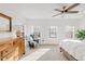 Spacious bedroom with a ceiling fan, dresser, and large windows for natural light at 11905 Quitman St, Westminster, CO 80031