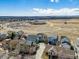 An aerial view shows the neighborhood with a distant view of mountains and open spaces at 3812 Red Deer Trl # D, Broomfield, CO 80020