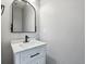 Modern bathroom featuring a white vanity with marble countertop and a decorative mirror at 3812 Red Deer Trl # D, Broomfield, CO 80020