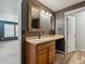 The powder room features a wood vanity with rustic framed mirror and adjacent bedroom access at 3812 Red Deer Trl # D, Broomfield, CO 80020