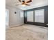 An empty bedroom featuring two windows and a ceiling fan at 3812 Red Deer Trl # D, Broomfield, CO 80020