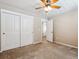 Spacious bedroom features a ceiling fan and closet at 3812 Red Deer Trl # D, Broomfield, CO 80020