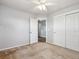 A neutrally painted bedroom features white trim, ceiling fan, and a large closet at 3812 Red Deer Trl # D, Broomfield, CO 80020