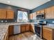 Well-lit kitchen featuring stainless steel appliances, granite countertops, and wood flooring at 3812 Red Deer Trl # D, Broomfield, CO 80020