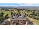 An aerial view of luxury apartments showcasing landscaping, mature trees and mountain views at 4625 W 50Th Ave # 110, Denver, CO 80212