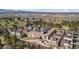 Aerial view showcasing the community's architecture, set against the backdrop of lush golf courses and distant cityscapes at 4625 W 50Th Ave # 110, Denver, CO 80212